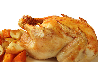 Roast chicken with baked vegetables, ready for serving.