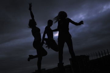 Fototapeta premium group of people jumping in air in night