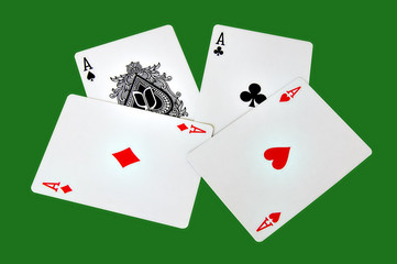 Four aces isolated in a green background with clipping path
