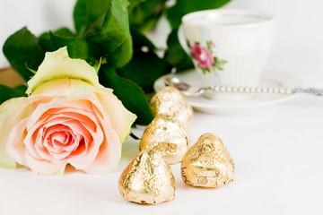 fresh rose candy and cup over ehite