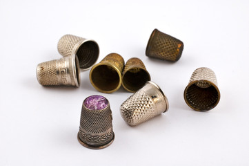 Old fashioned thimbles on white background with selective focus