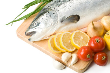 Fresh raw salmon with vegetables on a white background