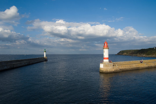 Entrance to a harbour with protecting breakwater and lighthouses