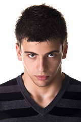 Portrait of a young man with a tough expression. Studio shot. I