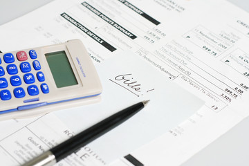 monthly billing statement with pen and calculator. - obrazy, fototapety, plakaty