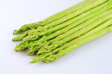 bunch of asparagus spears isolated in white background.
