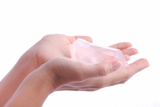 Hands holding quartz - semiprecious gems are  used in esoteric