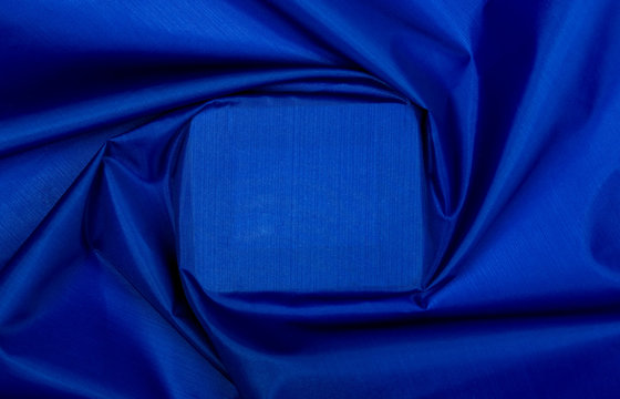There is blue textile texture with square in center