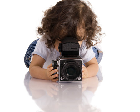 child with old SLR camera