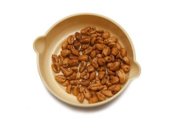 granules in yellow plate isolated on white