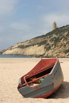 A stranded boat on a deserted beach in Cadiz, South of Spain