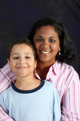 Portrait of a minority woman and son on black background