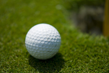 Golf club view of Golf ball in the putting green - sport