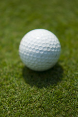 Golf club view of Golf ball in the putting green - sport