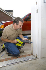 Carpenter repairing exterior door casing, of casing