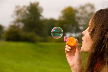 Cute girl blowing bubbles