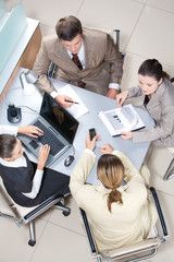 Above view of working business group sitting at table