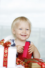 Little girl opening Christmas presents