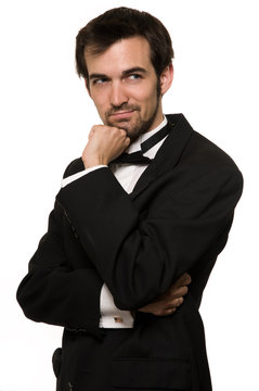 Attractive young brunette man  wearing a black tuxedo