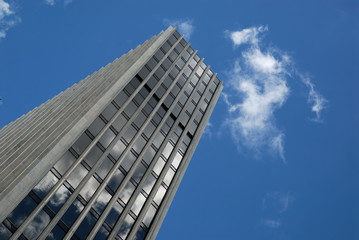 Obraz na płótnie Canvas office building with a blue sky and clouds