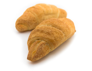 two fresh croissants on white background