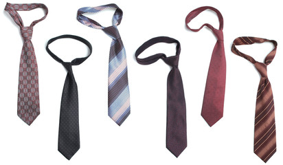 Many different ties are on a white background