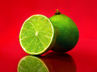 Lime fruit, isolated on red background