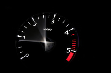 moving revs meter of a sports car on a black background.