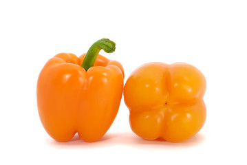 Two orange peppers isolated on white