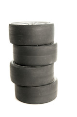 Four used race tires on white background