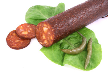 sausage with lettuce and pepper isolated on white