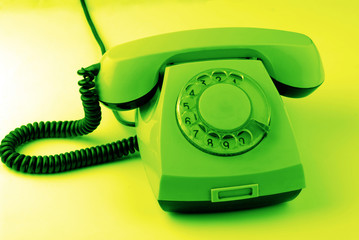 old disk phone on  green background
