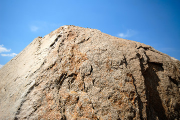 big granite stone on  background of  sky