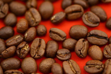 Coffee beans on red background