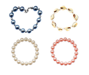 four bracelets made of seashells and artificial pearls