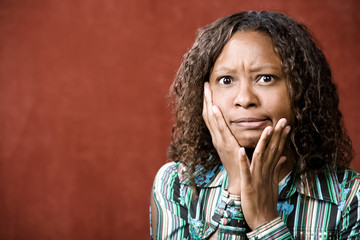Fototapeta na wymiar Close-Up Portrait of a Stressed African-American Woman