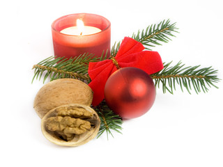 Christmas still life with Christmas ball, candle and walnuts