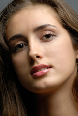 Obraz premium portrait of the young girl on dark background in studio