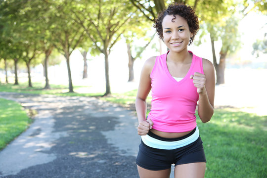 A Young Pretty African American Woman Jogging In The Park