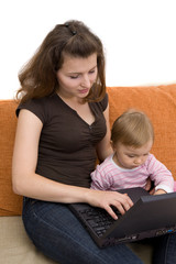 happy family sitting on sofa with laptop