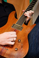 Musician playing  an electric guitar cropped