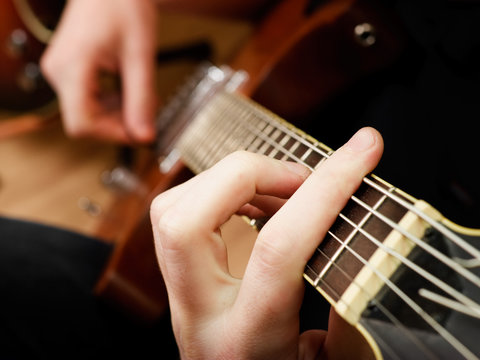 Musician playing  electric guitar, shallow depth of field