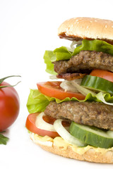 detail of a home made hamburger on a white plate