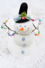 Snowman on white shiny garland making a background