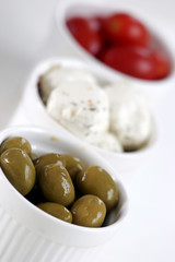 Breakfast with cheese, olive and tomato.