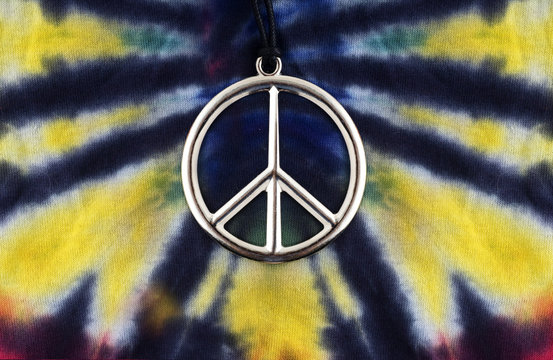 Tue dye shirt with peace sign necklace