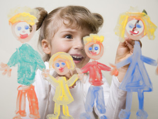 Cute  girl painting family on glass