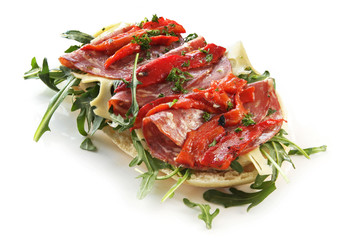 Focaccia bread with rocket leaves, salami, Swiss cheese