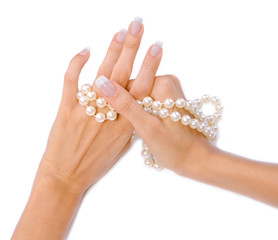 Beautiful woman`s hands with pearls