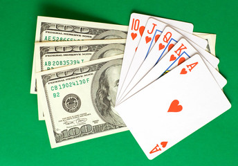 cards and money on a green cloth